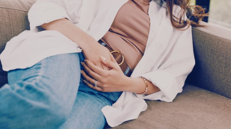 woman feeling pain from period lying down